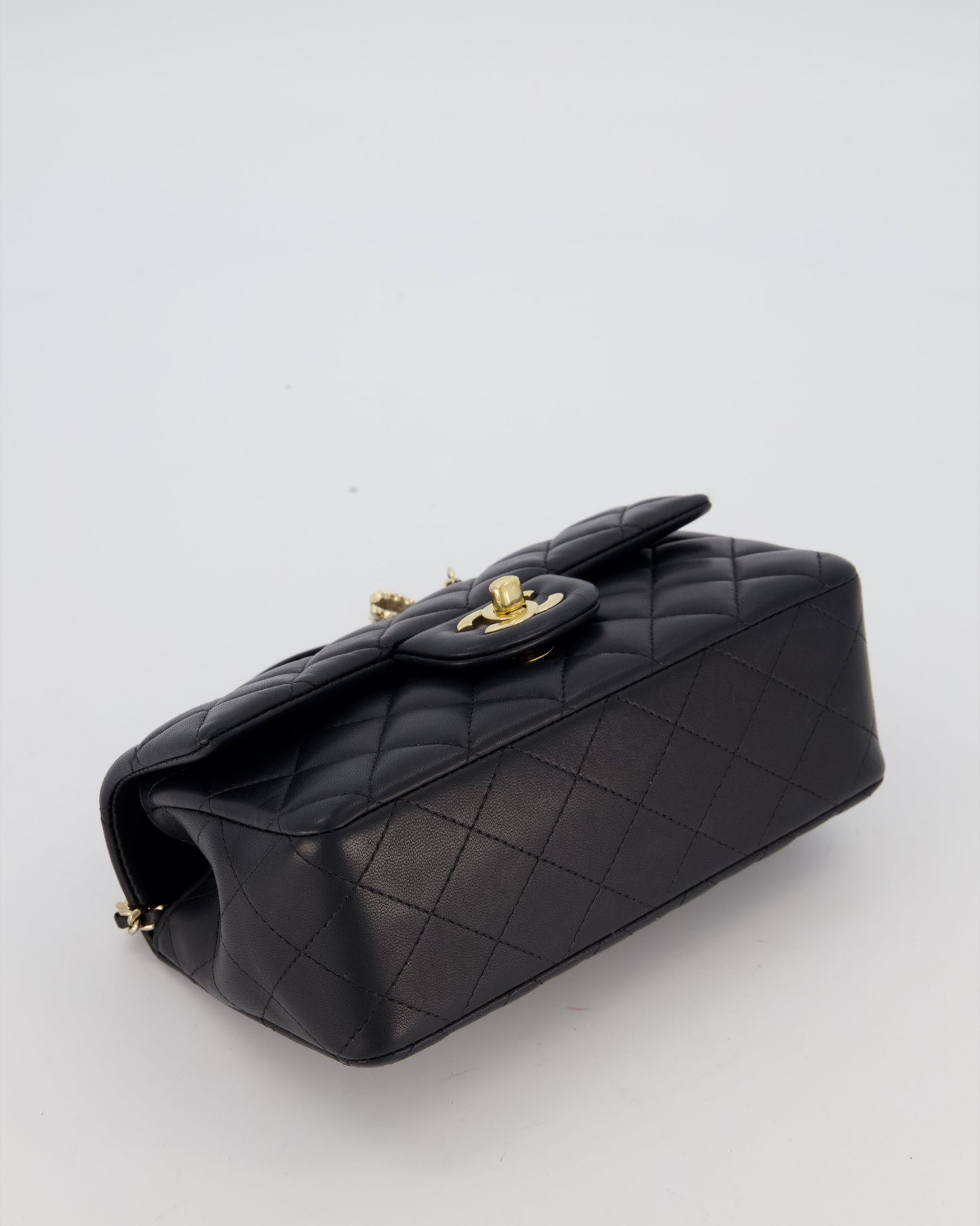 Chanel Black Mini Rectangular Top Handle Flap Bag in Lambskin Leather with Champagne Hardware and Strass Removable Bow Charm